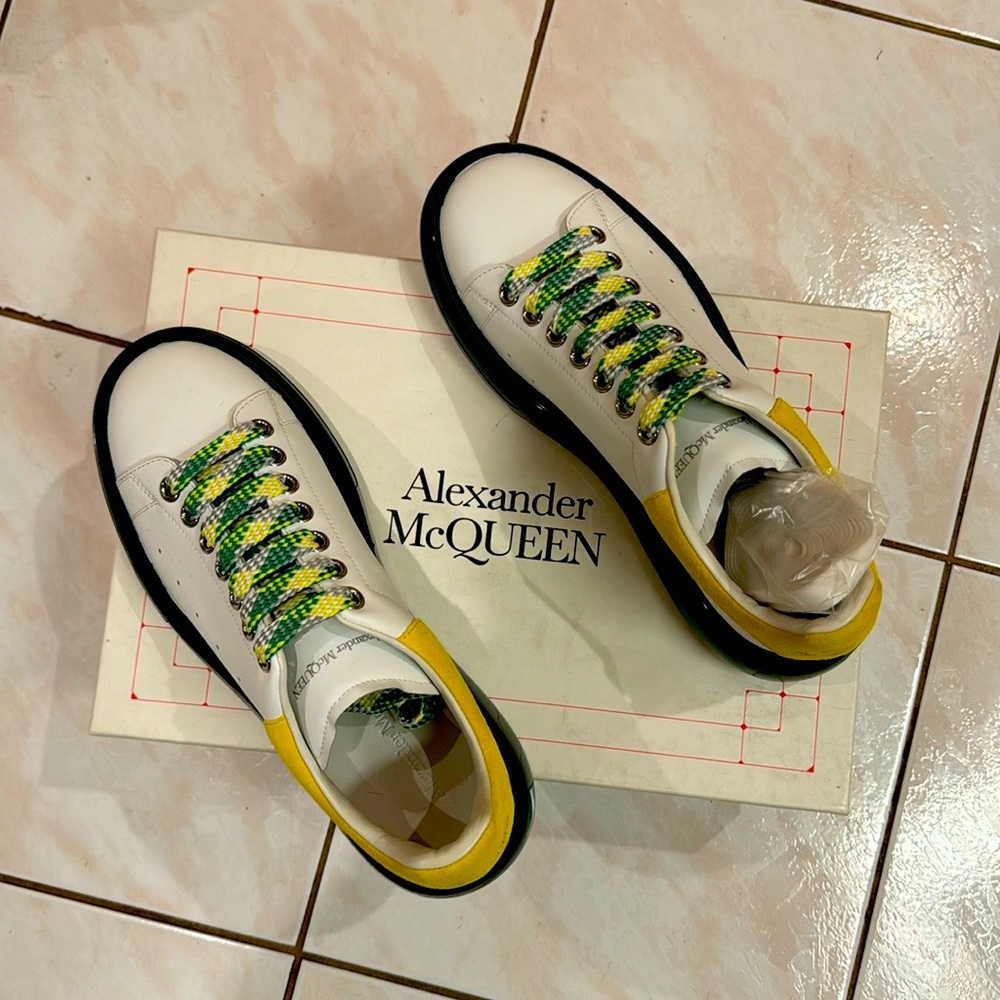 Alexander McQueen Larry Sneakers. Champagne white with green and yellow accents.